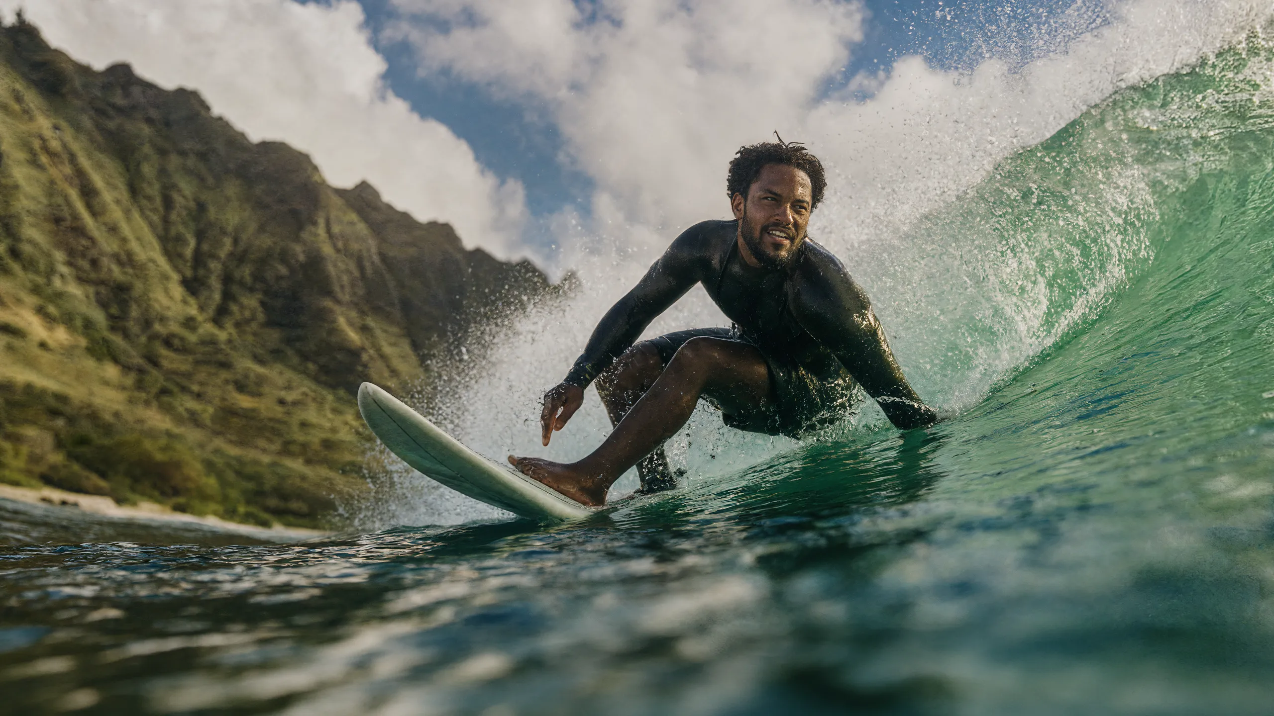 Surfer carving across the face of a breaking wave